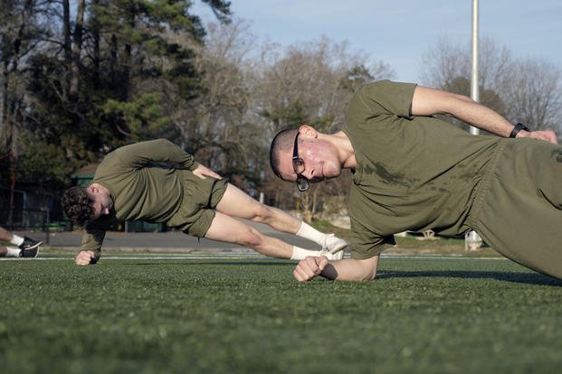 Students approximate a PT routine workout for the Marine Corps Officer Candidates School. 