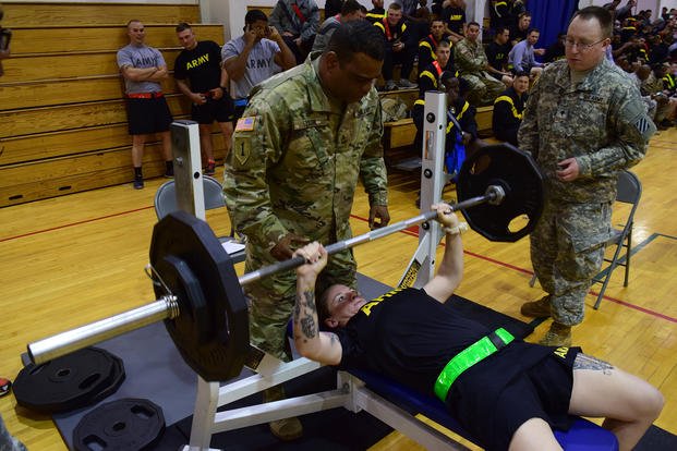 A soldier competes in a bench press competition at Fort Stewart.