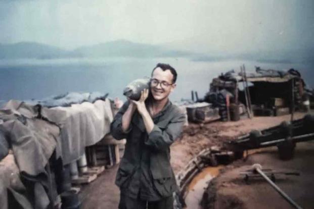 Lindsay Bennett’s grandfather with a Howitzer round during the Vietnam War