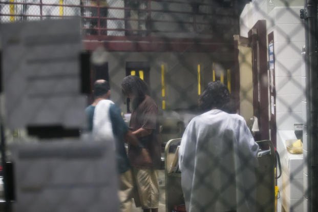 In this photo reviewed by Detainees interact inside the Camp VI detention facility in Guantanamo Bay Naval Base, Cuba.