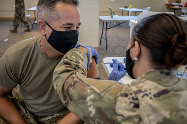 A major in the Hawaii National Guard receives the COVID-19 vaccine.