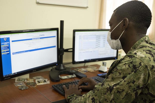 A yeoman third class uses the Transaction Online Processing System.