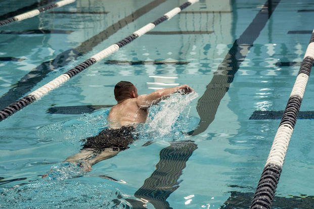 A hospitalman swims laps.