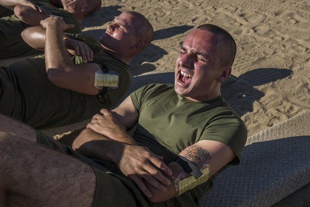 A Marine recruit performs crunches during a physical training session.