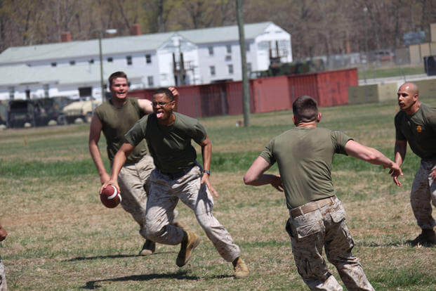 A Marine runs for a touchdown during a football game at Fort Pickett.