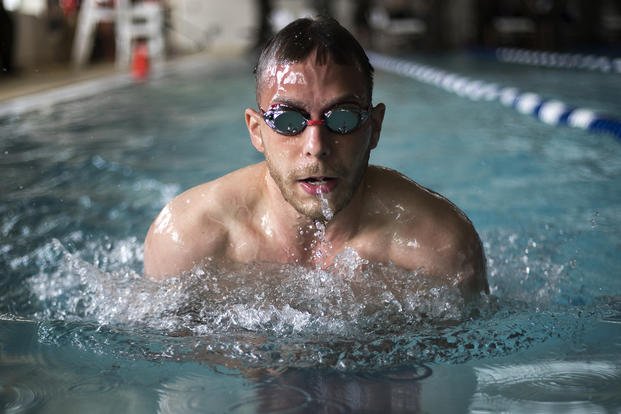 An athlete comes up for air as he performs the breaststroke during the 2018 Marine Corps Trials swimming competition.