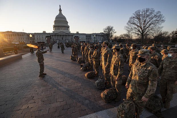 New Jersey National Guard soldiers and airmen from 1st Battalion, 114th Infantry Regiment, 508th Military Police Company, 108th Wing, and 177th Fighter Wing arrive near the Capitol to set up security positions in Washington, D.C.