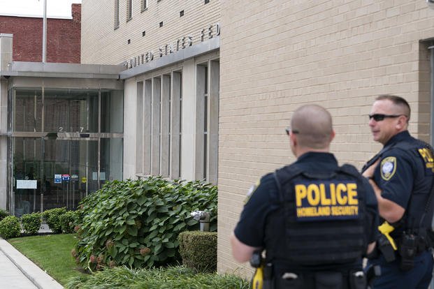 Homeland Security police officers stand outside of the U.S. District Courthouse where Jonathan and Diana Toebbe have their hearing in Martinsburg, W.Va.