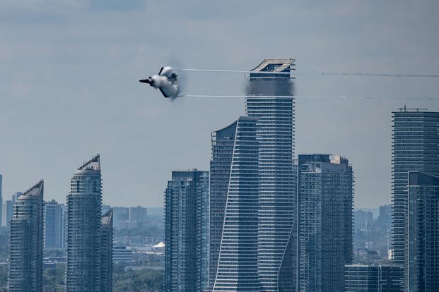 Air Force Maj. Kristin "BEO" Wolfe, F-35A Lightning II Demonstration Team pilot and commander, flies over the Toronto skyline during the 2021 Canadian International Air Show.