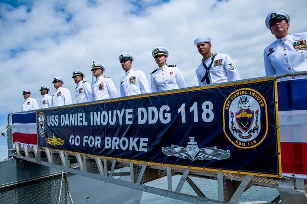 After manning the ship, officers stand on the gangway during the commissioning ceremony for the USS Daniel Inouye at Pearl Harbor, Hawaii.