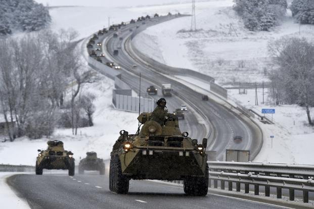 convoy of Russian armored vehicles moves along a highway in Crimea