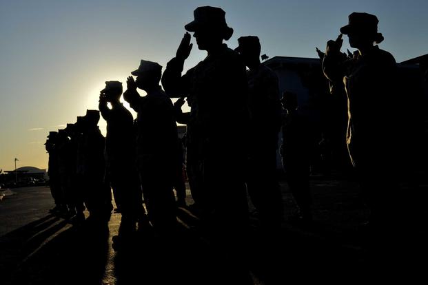 U.S. Marines salute during a promotion ceremony