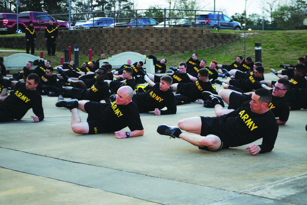Incoming soldiers stretch out after a run during newcomers PT at Fort Polk.