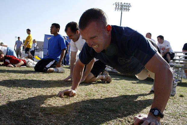 Athletes battle through two minutes of push-ups during the Navy SEAL Fitness Challenge.