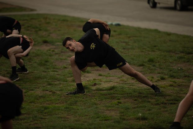 An Army chaplain leads a company in yoga.