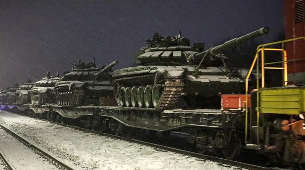 Russian army tanks are loaded onto railway platforms.