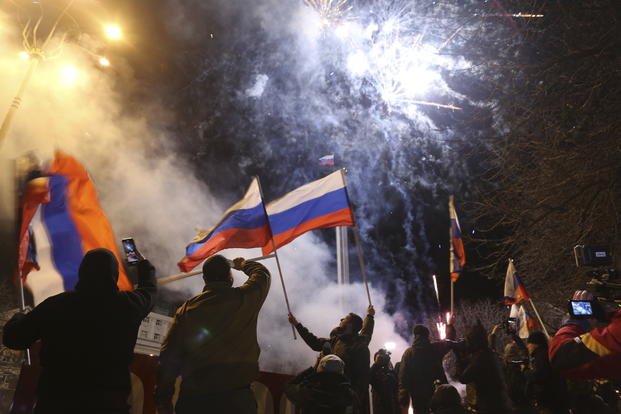People waving Russian national flags in the center of Donetsk.