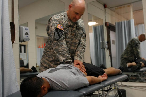 A soldier is checked for lower-back pain at Fort Hood.