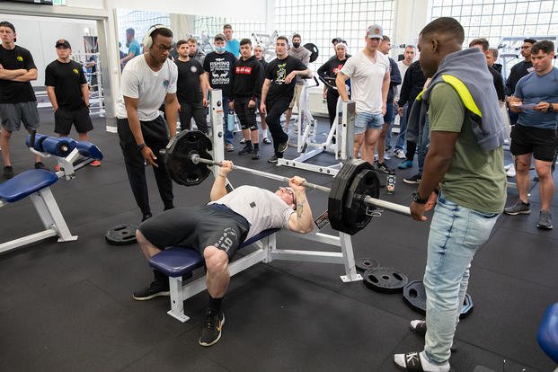 A soldier tests himself on the bench press.
