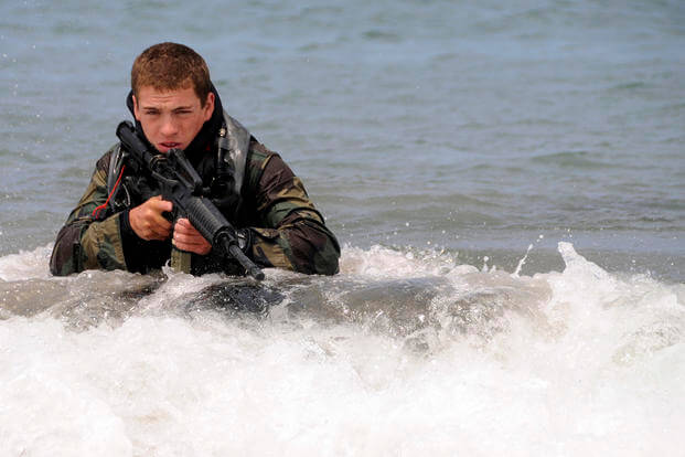 A Basic Underwater Demolition/SEAL (BUD/S) student wades ashore on San Clemente Island during an over-the-beach exercise.