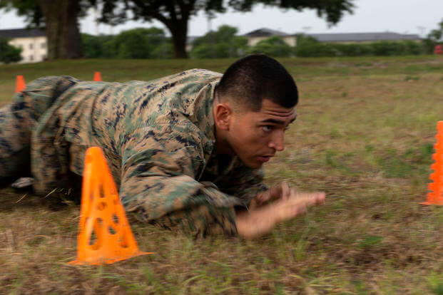 A Marine low-crawls during a combat fitness test on Keesler Air Force Base, Mississippi.