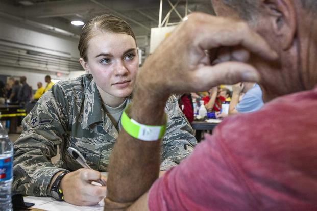 Airman performs a health assessment on a homeless veteran