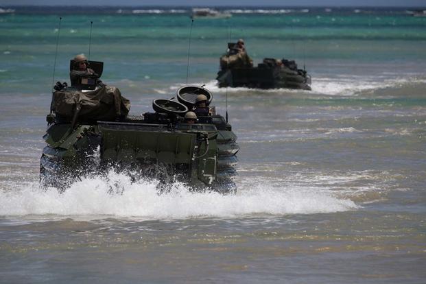 Marines conduct waterborne operations with AAVs at Camp Schwab.