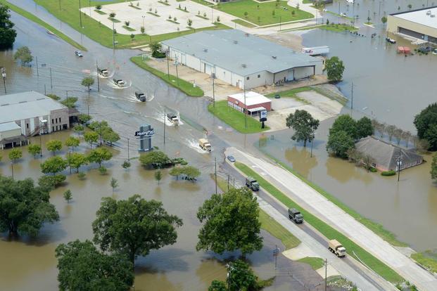 Louisiana National Guard tactical vehicles transport flood relief supplies