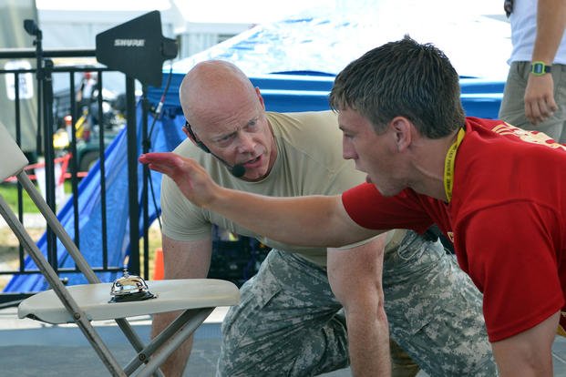 U.S. Army Staff Sgt. Ken Weichert motivates a scout during a fitness challenge.