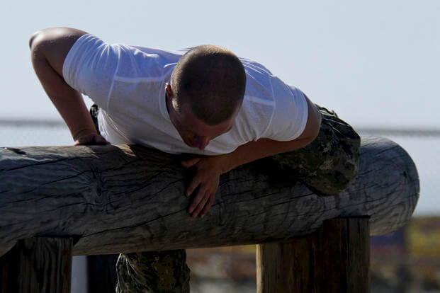 A Basic Underwater Demolition/SEAL (BUD/S) candidate negotiates an obstacle at the Naval Special Warfare Center.