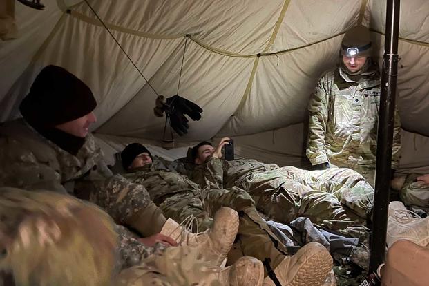Soldiers rest in their squad tent during a training exercise in Alaska.