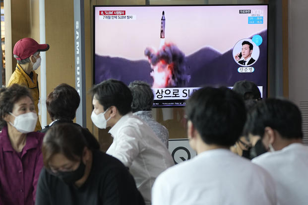 People watch a TV showing a file image of North Korea's missile launch during a news program at the Seoul Railway Station in Seoul, South Korea.