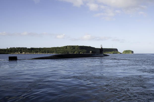 The Ohio-class guided-missile submarine USS Ohio departs Guam.