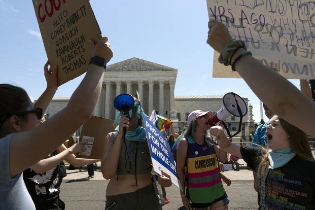 Anti-abortion demonstrators and abortion right activists protest outside the Supreme Court in Washington.