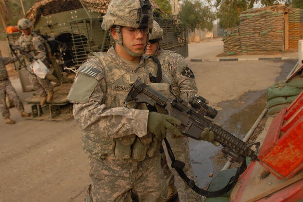 After a patrol, Pfc. Estaban Fernando performs weapon-clearing procedures for his M4 carbine