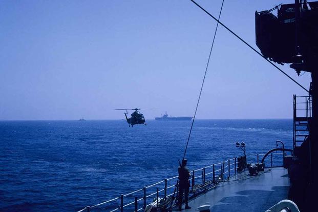 Navy helicopter lands on the USS Little Rock near where the USS Liberty.