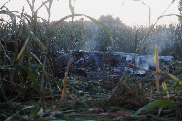 Debris of an Antonov cargo plane smolders in Palaiochori village in Greece.