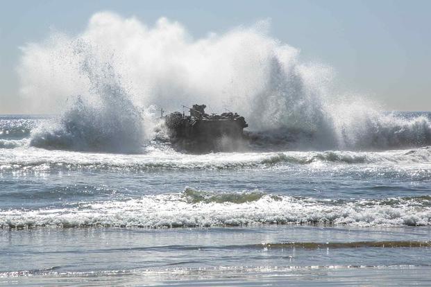 A U.S. Marines ACV passes through the surf.