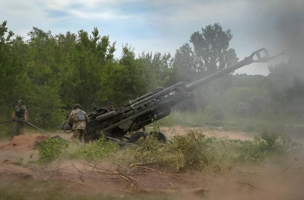 Ukrainian soldiers fire a U.S.-supplied M777 howitzer in Ukraine.