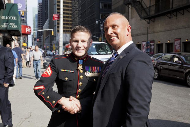 Retired U.S. Marine Corps Cpl. William Kyle Carpenter, left, poses for a photo during a visit to New York City after receiving the Medal of Honor in 2014.