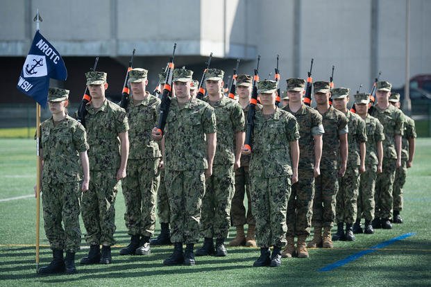 Navy ROTC midshipmen stand in formation.