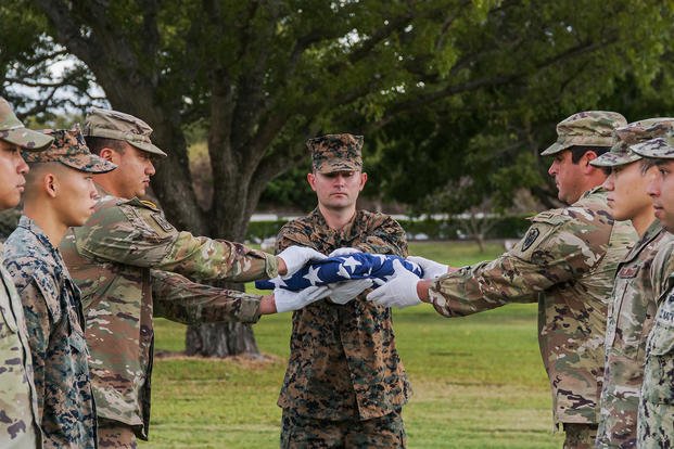 U.S. service members with the Defense POW/MIA Accounting Agency (DPAA) honor the fallen during a disinterment ceremony Feb. 7, 2022, at the National Memorial Cemetery of the Pacific in Honolulu. 