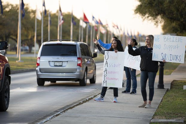 Sexual assault response advocates wave to drivers during the “Stand Against Sexual Assault” drive-by campaign at Joint Base San Antonio-Randolph, Texas.