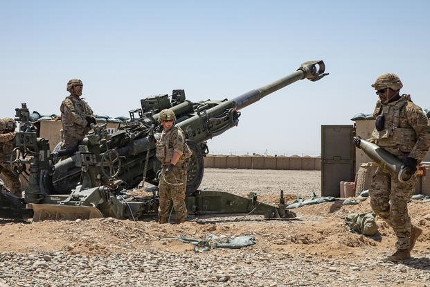 Soldiers from 1-118th Field Artillery Regiment of the 48th Infantry Brigade Combat Team prepare to fire an M777 Howitzer during a fire mission in Southern Afghanistan.
