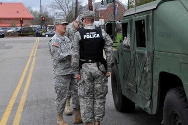 Greg Smith gets a status update at a military police position.