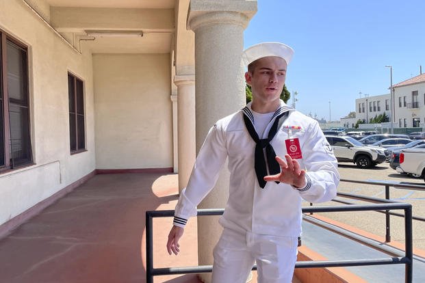 U.S. Navy sailor Ryan Sawyer Mays walks past reporters at Naval Base San Diego