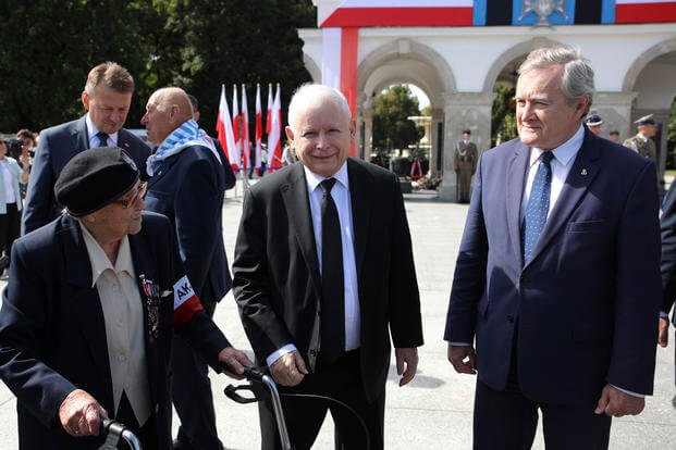 Poland's main ruling party leader Jaroslaw Kaczynski, center, attends a wreath laying ceremony