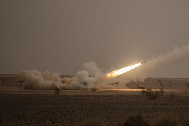 A launch truck fires the High Mobility Artillery Rocket System (HIMARS)