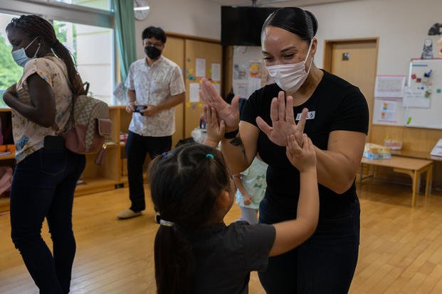 U.S. Marine Corps Sgt. Angelica Clark, a maintenance management specialist assigned to III Marine Expeditionary Force Information Group, celebrates with a student at Suginoko Preschool in Kin, Okinawa, Japan, Sept. 29, 2022. (Lance Cpl. Bridgette Rodriguez/U.S. Marine Corps photo) U.S. Marine Corps Sgt. Angelica Clark, a maintenance management specialist assigned to III Marine Expeditionary Force Information Group, celebrates with a student at Suginoko Preschool in Kin, Okinawa, Japan, Sept. 29, 2022.