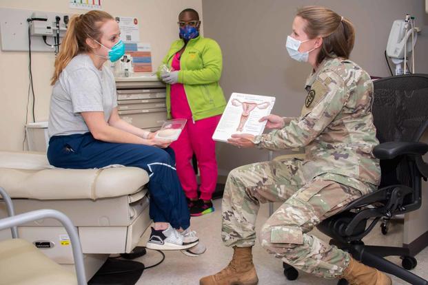 Army doctor discusses contraception options with a patient while a nurse prepares for an exam at the CPT Jennifer M. Moreno Primary Care Clinic, Fort Sam Houston, Texas, Oct. 20, 2021. (U.S. Army photo by Jason W. Edwards)